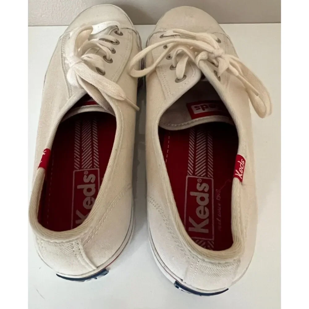 Keds low top canvas lace up sneakers with red trim. Size 8.